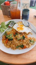 Half eaten vegetarian breakfast of vegetable fried rice with egg