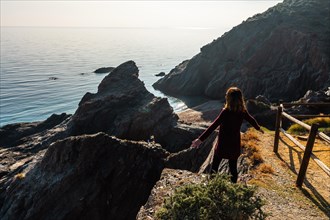 A young tourist looking at the beach in the Almanzora caves from above