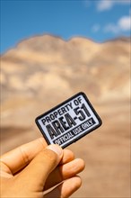 A young man with a patch for Area 51 clothing on Artist's Drive in Death Valley