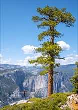 A young woman in Sentinel Dome looking at Upper Yosemite Fall
