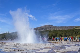 Geysir Strokkur with the sun in the background of the golden circle of the south of Iceland