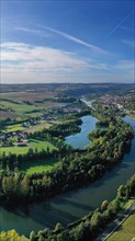 The river loop near Homburg am Main winds through the valley and is surrounded by trees and vineyards. Homburg