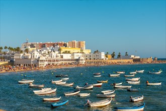 La Caleta beach full of tourism in the summer sunset of the city of Cadiz. Andalusia