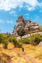 A young woman trekking enjoying the Torcal de Antequera on the green and yellow trail