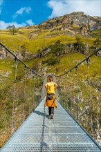 A young woman on the Holtzarte suspension bridge