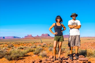 A couple looking at the point where the famous Forrest Gum movie was recorded in Monument Valley