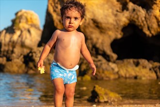 A boy on summer vacation at Praia dos Arrifes