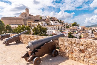 Medieval cannons of the Ibiza castle wall and the cathedral in the background