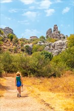 A young woman trekking in the Torcal de Antequera on the green and yellow trail