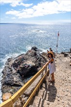 A young tourist descending the stairs to reach the cove of Puerto de Puntagorda