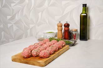 Raw meatballs on a kitchen table ready for frying