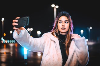 Caucasian brunette taking a selfie on the phone