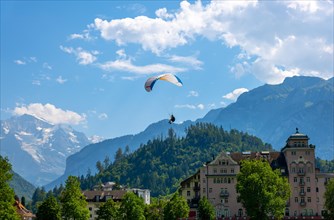 Paragliding in Front Of Snow Capped Jungfraujoch Mountain in a Sunny Day in Interlaken