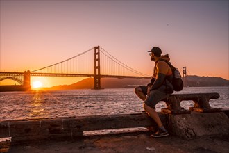 A man in red sunset at the Golden Gate of San Francisco. United States