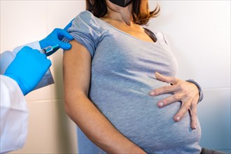 A young pregnant woman receiving the coronavirus vaccine. Antibodies