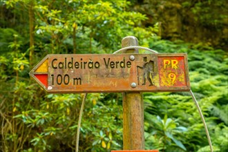 Signs on the trekking trail next to the waterfall in Levada do Caldeirao Verde