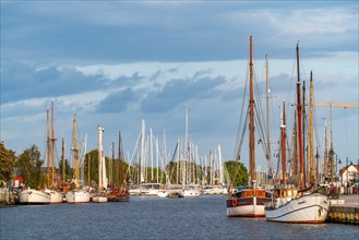 Sailing yachts and traditional sailing ships on the river Ryck in the harbour of Greifswald