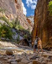 A young couple in the Interior of the Zion national park canyon. United States