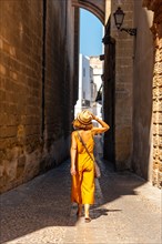 A woman walking through the historic center of Arcos de la Frontera in Cadiz