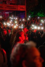 Crowd with mobile phone lights at Live Klostersommer Festival in Historic Monastery