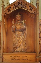 Sculpture of Jesus with orb on late Gothic altar with inscription