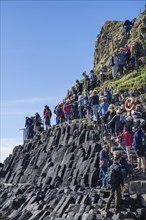 Massive tourist crowds on the uninhabited rocky island of Staffa