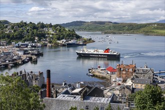 View over the harbour town of Oban to the ferry harbour with the ferry Isle of Lewis operating between Oban and Isle of Barra