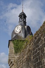 Bell tower with clock and the massive walls of the old town of Concarneau