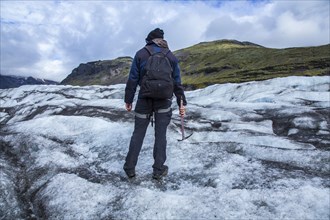 A young tourist on the ice of the Svinafellsjokull glacier. Iceland