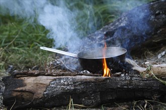 Preparing food on a campfire