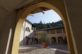 View through archway onto arcaded courtyard Chiostro della Pieve