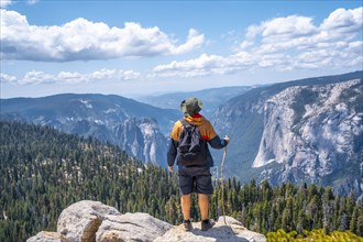 A young man with a stick for walking in Sentinel Dome in Yosemite National Park. United States