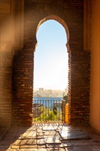 Sunset from the Arab doors of a courtyard of the Alcazaba in the city of Malaga