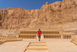 A young woman visiting the Mortuary Temple of Hatshepsut without people on her return from tourism in Luxor after the coronavirua pandemic