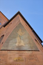 Historic mural with Madonna figure and halo with baby Jesus at the corner of Heiliggeistkirche