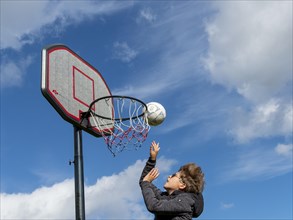 Basketball jumping with the ball to the basket and net