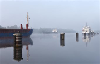 Cargo ship in fog in the Kiel Canal