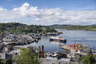 View over the harbour town of Oban to the ferry harbour with the ferry Isle of Lewis operating between Oban and Isle of Barra