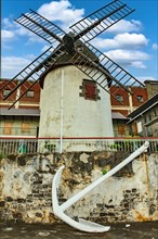 Historic windmill today museum built 1736 on waterfront historic harbour of Port Louis capital of Mauritius island