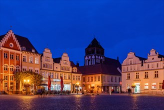 Architecture on the historic market square with town houses and St. Mary's Church at the blue hour