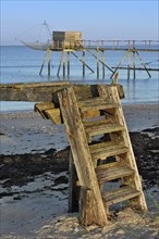 Traditional carrelet fishing hut with lift net on the beach