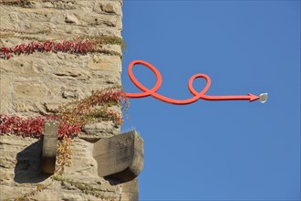 Sculpture red arrow with bow and cup at the historic Pfeifferturm