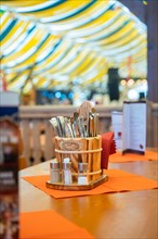 Cutlery basket on beer table in marquee