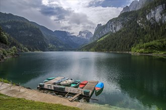 Pleasure boats moored at wooden jetty in the Vorderer Gosausee near Gosau