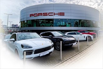 View of futuristic looking building with typical reduced architecture of showroom sales house of car brand car manufacturer Porsche with lettering Porsche at representation of car dealer Gottfried Sch...