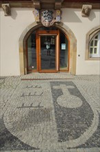 City coat of arms as floor mosaic in front of the historic town hall