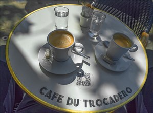 Two espressos on a bistro table in a cafe