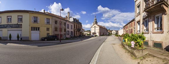 Crossing of the village with decoration for the Tour de France and the Eglise Sainte-Catherine in Provencheres-et-Colroy