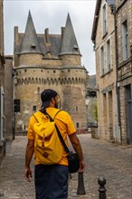 A young tourist at the medieval castle of Vitre. Ille-et-Vilaine department