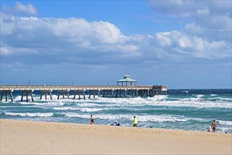 Stormy weather and pier in winter at Surfside Beach along the Atlantic Ocean in Miami-Dade County